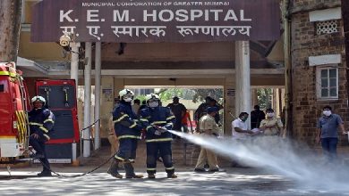 Firefighters disinfect the exteriors of a government-run hospital to limit the spreading of coronavirus disease (COVID-19), in Mumbai