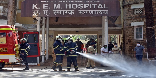 Firefighters disinfect the exteriors of a government-run hospital to limit the spreading of coronavirus disease (COVID-19), in Mumbai