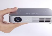 CA_MiniProjector_HoldingFront_Silver