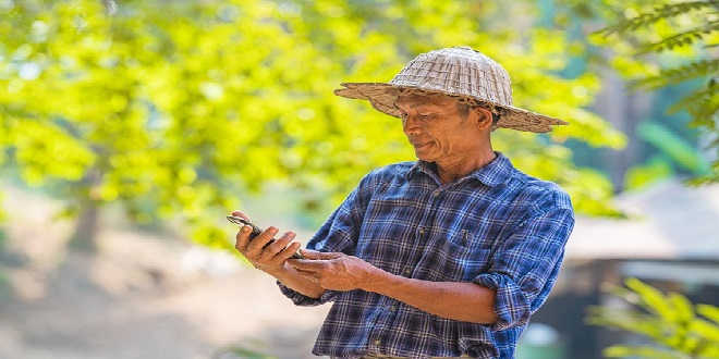 Farmer Asian with smartphone and laptop,Business and technology concept