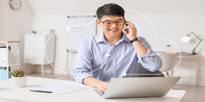 Young Asian businessman talking by phone in office
