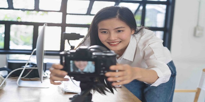 Influencer and content creator in digital marketing concepts. Young woman adjusting her digital camera prepare for record video content to her channel.