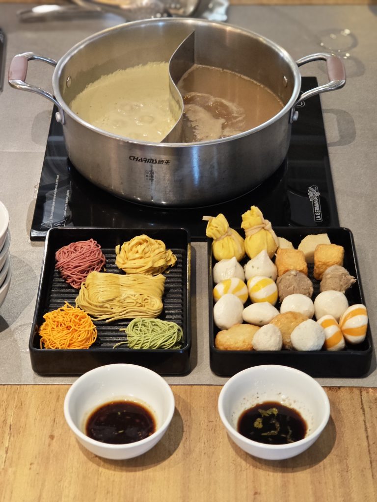 Champion Hot Pot Different Ingredients, dumplings, soup broth, noodles and sauce.