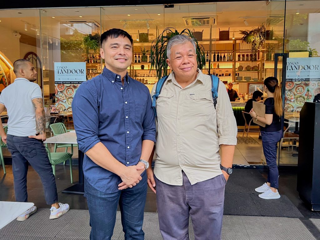 Marvin Agustin, the owner of Tango Tandoori with Ted Claudio of Wazzup.ph  standing and smiling