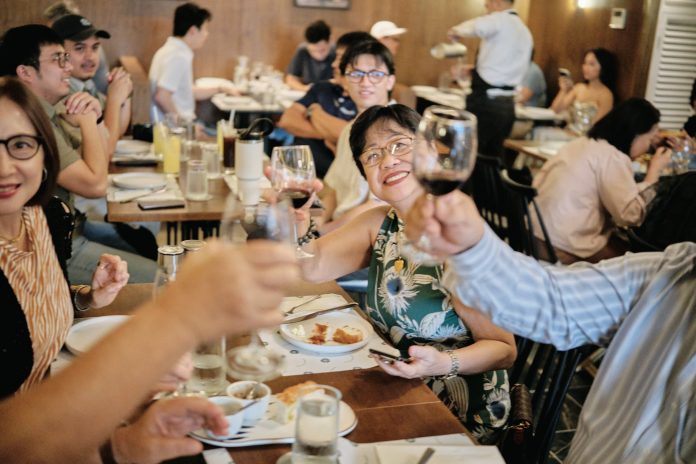Three generations toast around the table